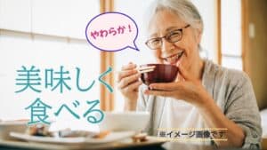 シニアの女性が食事をしている。テキストにやわらかの吹き出しと美味しく食べるの太文字入り